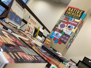 Various books displayed on a table and a sign that reads Native American Heritage Month