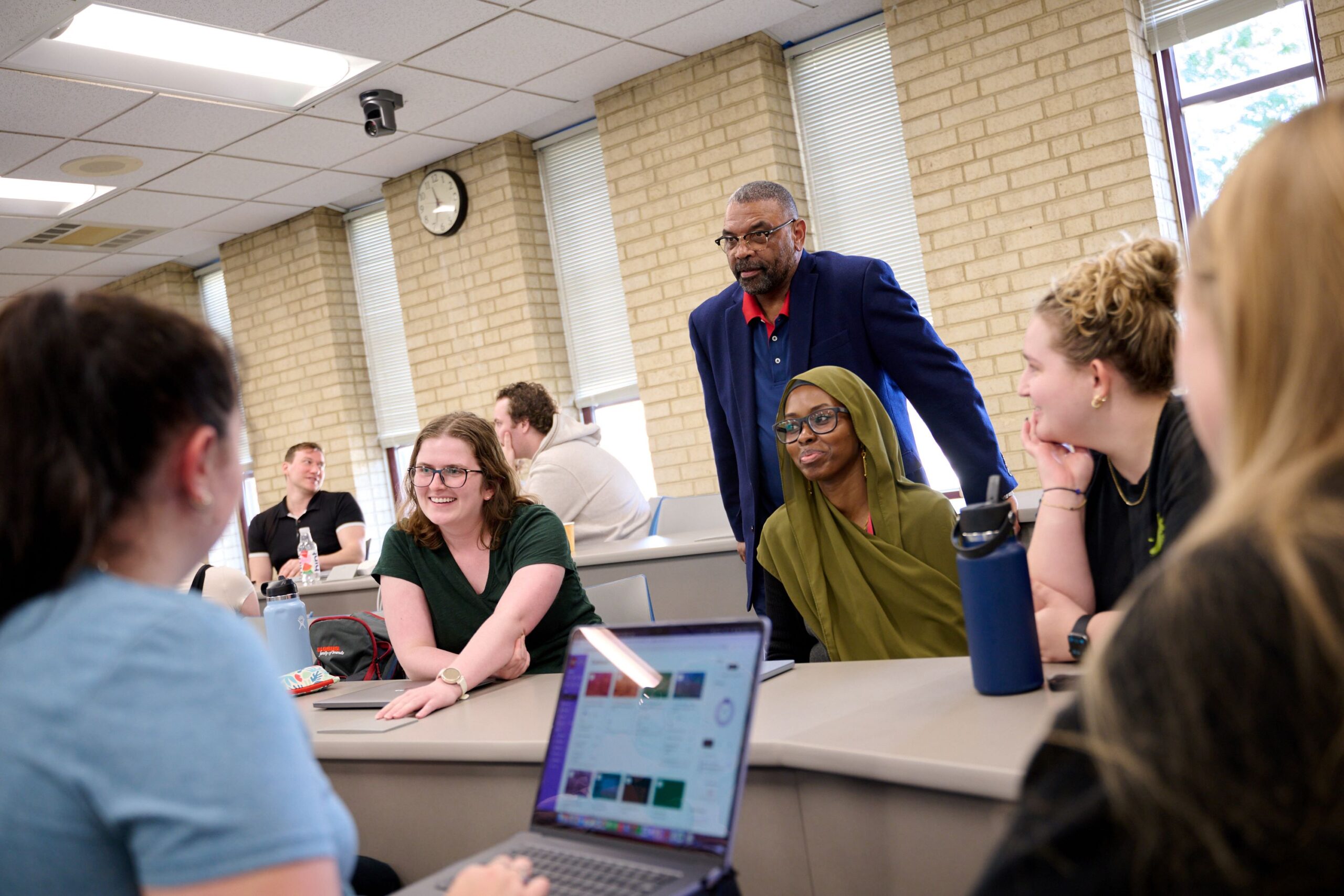 classroom scene with a professor and several students
