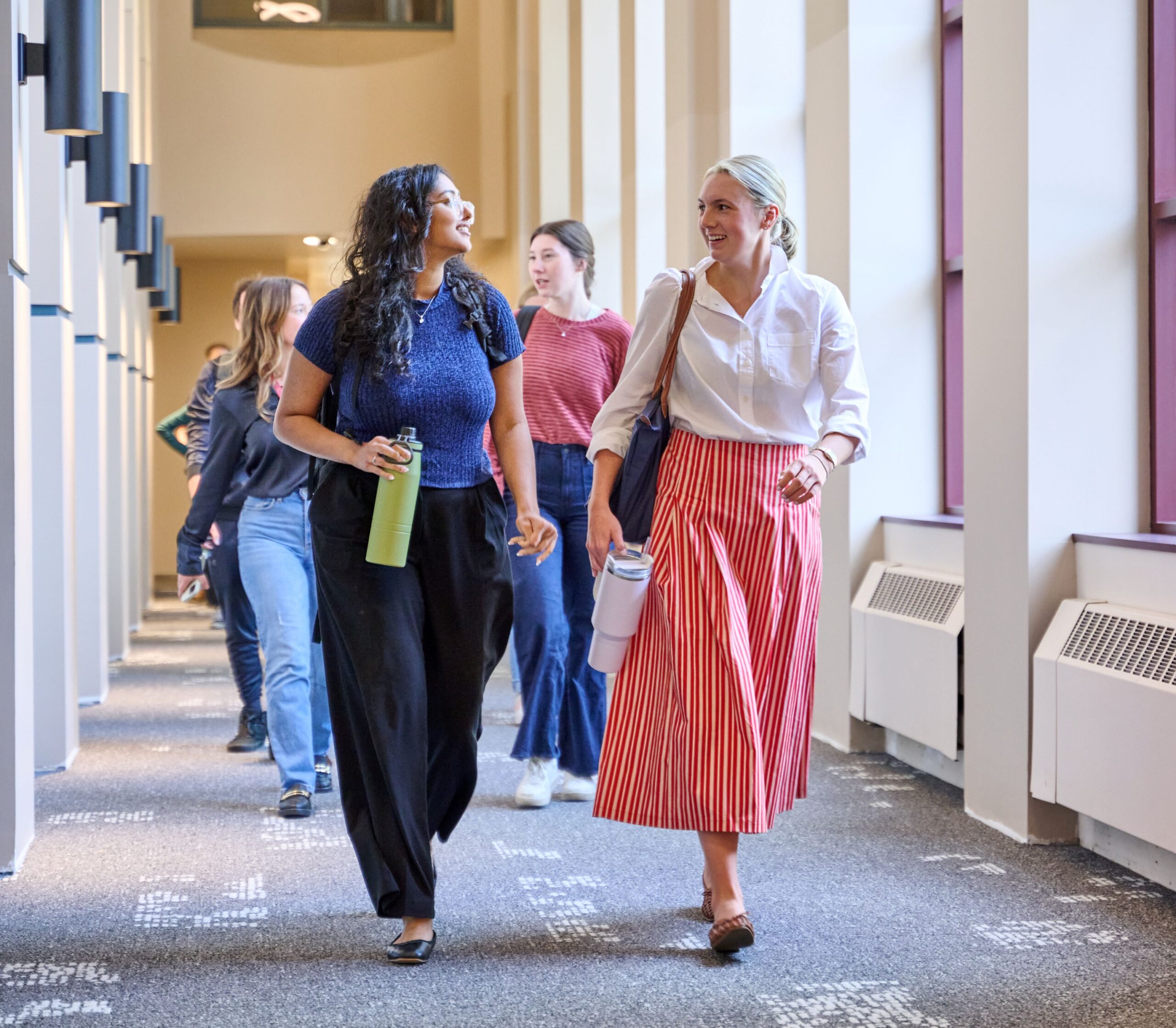students walking down a hallway