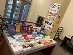 A table with various books displayed and a sign that says "Get smarter faster with these study guides"