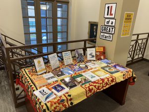 Books displayed on a table and a sign that says 1L of a Great Start!