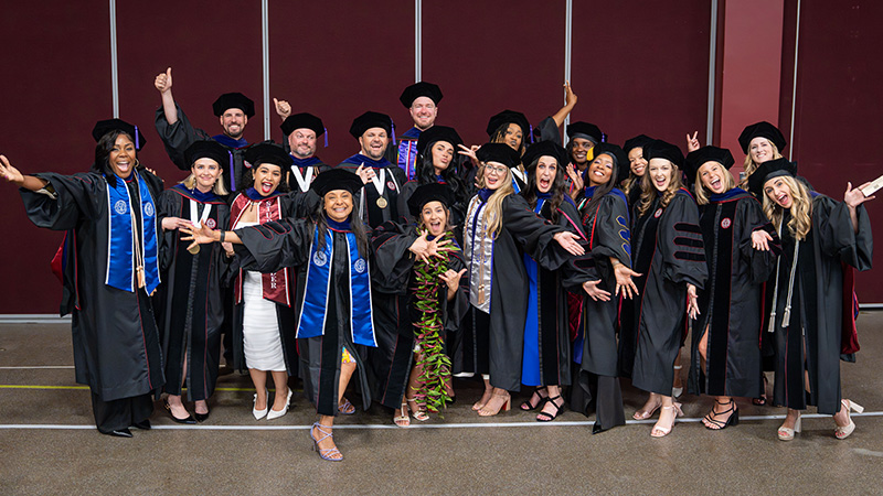 Graduates pose at Commencement 2026
