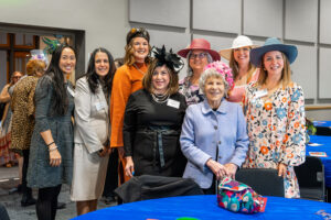 Former Justice Esther M. Tomljanovich ’55 (in pink hat) with alumnae attending the Tea.