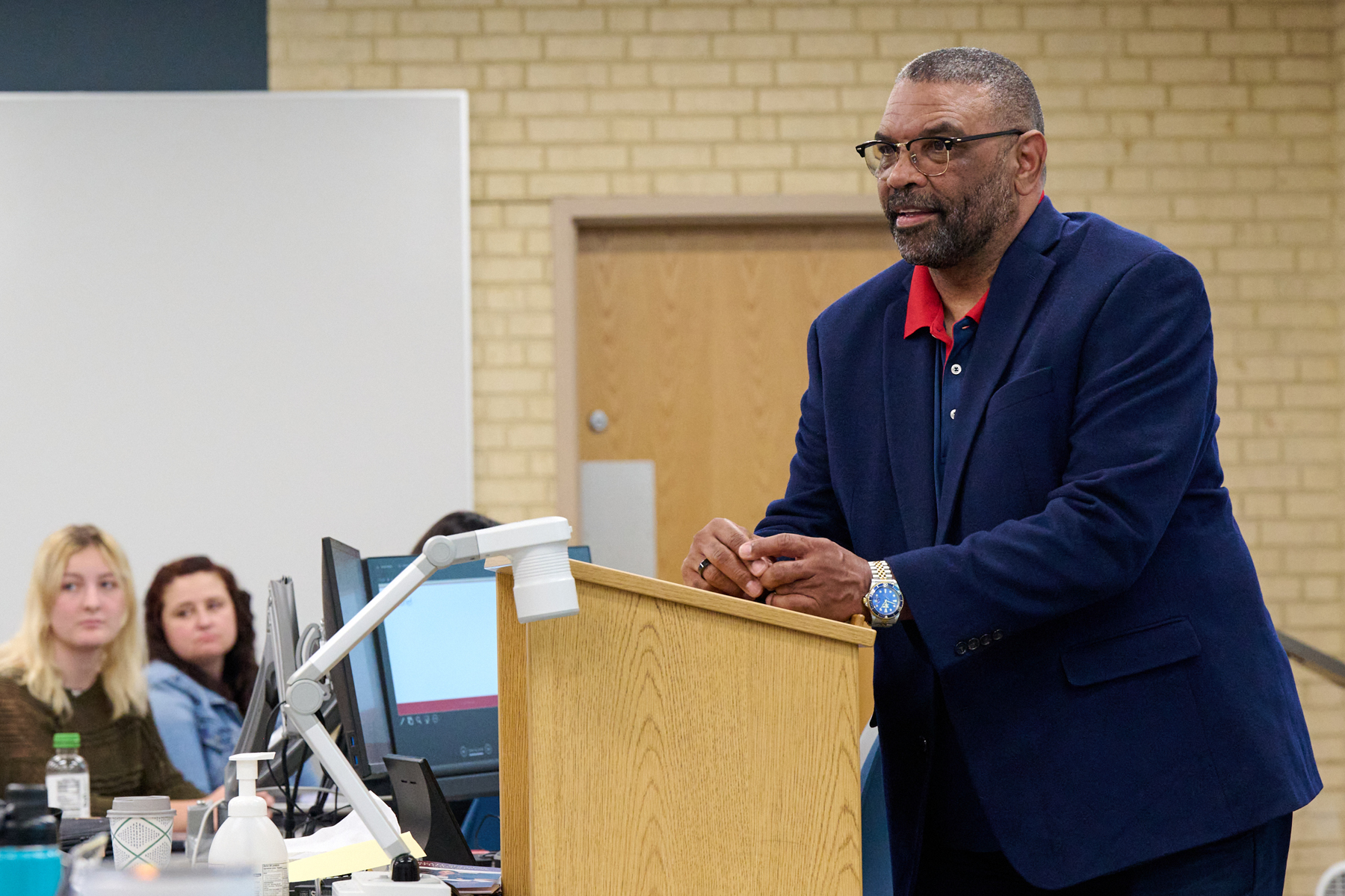 Professor speaking at podium