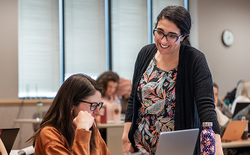 Professor speaking to student in seat