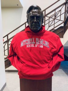 Statue of Warren Burger in a red Mitchell Hamline hoodie