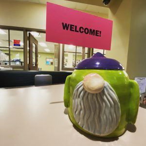 Ceramic gnome holding a welcome sign