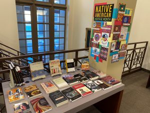 Various books displayed on a table and a sign that reads Native American Heritage Month